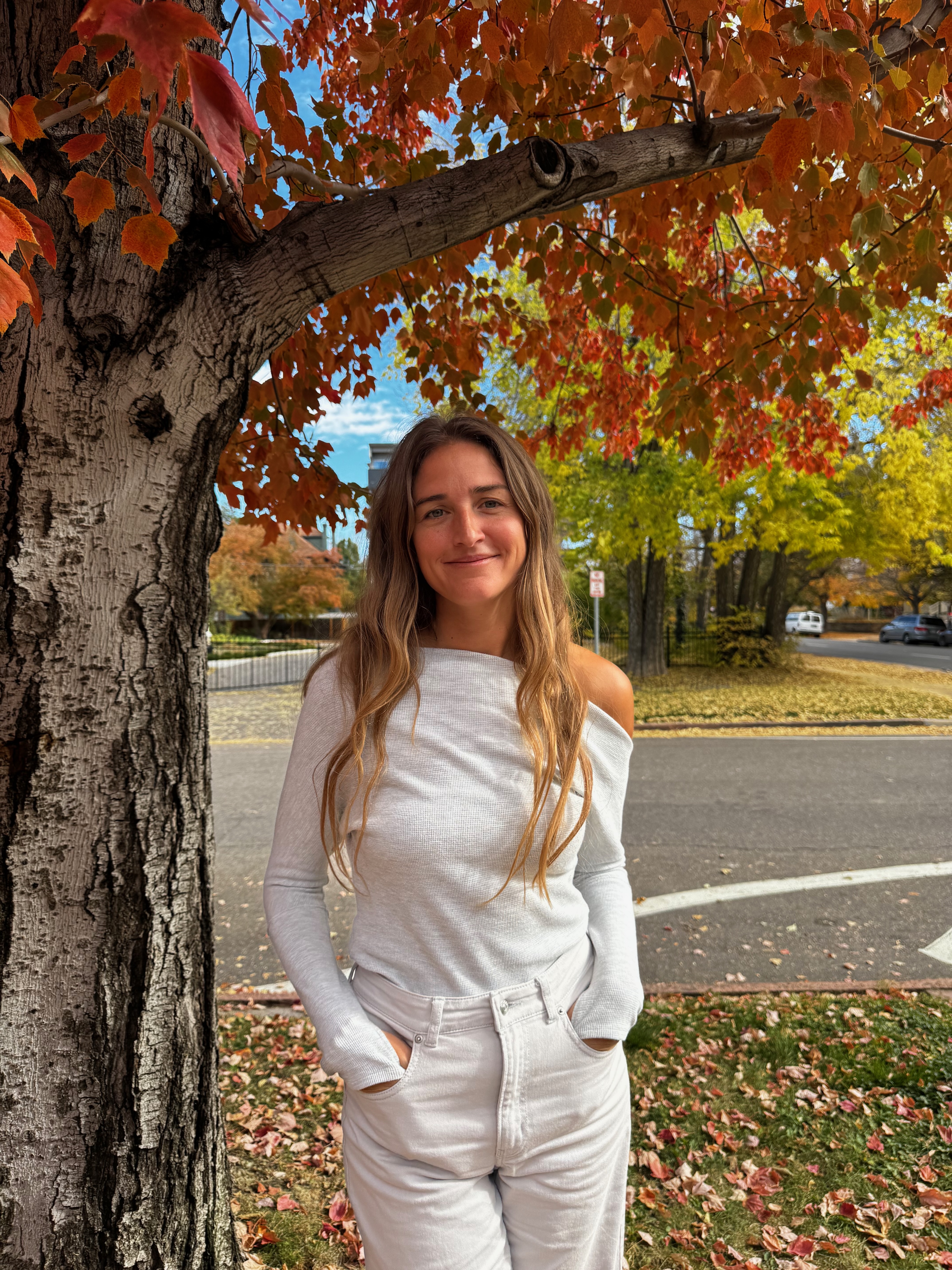 Carley Juel Stanley smiling and holding tarot cards